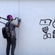 Sheefy McFly working on a mural in Detroit